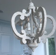 a chandelier hanging from the ceiling in a kitchen