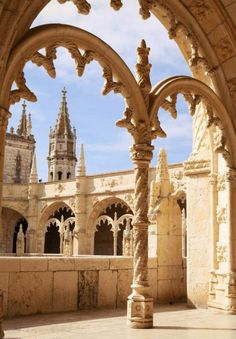 an arch in the middle of a building with arches and towers on each side,