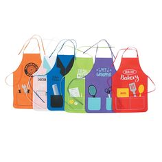 six aprons with different colors and designs on them, all lined up in a row