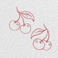 two cherries with leaves and hearts drawn on paper