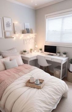 a bedroom with a bed, desk and computer on the table in front of it