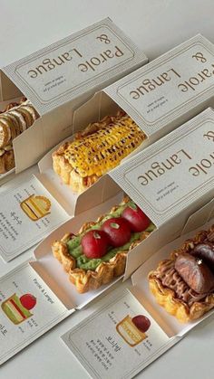 there are many different types of food in the boxes on this counter top, including pies and pastries