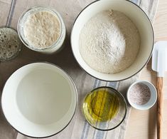 three bowls with different types of food in them on a table next to utensils