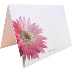 a greeting card with a pink flower on it