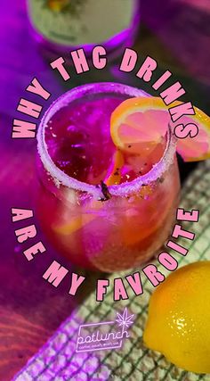 a pink and purple drink with lemons on the side