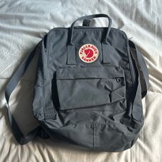 Never Used Grey Backpack With Lots Of Room And Storage And Adjustable Straps And Side Pockets As Well As Another Front Pocket All With Zippers Grey Backpack, Grey Backpacks, Kanken Backpack, Fjallraven Kanken, Fjallraven Kanken Backpack, Front Pocket, Adjustable Straps, Backpacks, Zipper