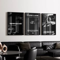 three black and white posters hanging on the wall above a leather couch in a living room