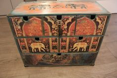 an ornately painted chest with elephants on it