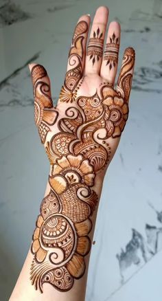 the hand is decorated with henna designs