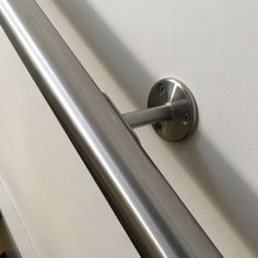 a metal handle on the side of a white wall