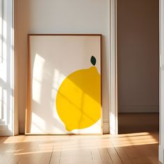 a yellow lemon on a white wall in an empty room with sunlight coming through the window