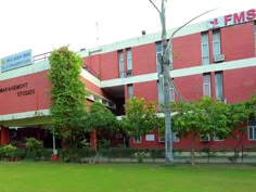 a red brick building with trees in front of it