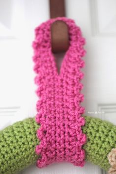 a crocheted scarf hanging on the front door