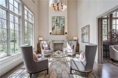 Luxury sitting area with high ceilings and fireplace with chandelier