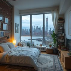 a bedroom with a large window overlooking the water and cityscape in the background