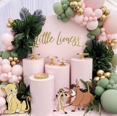 the lion king birthday party with pink and gold decorations, balloons, and greenery