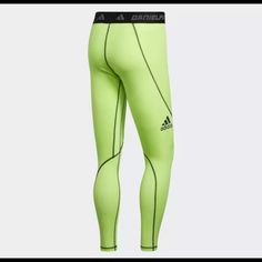 the adidas leggings are neon green and have black trimming on them