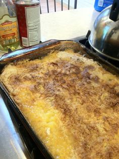 an uncooked casserole sitting on top of a stove next to a pot