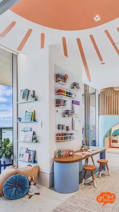 a room with a desk, bookshelf and chairs