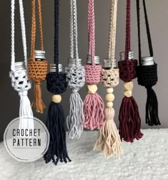 the crochet tassels are hanging from hooks