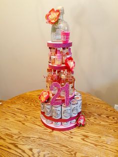 a tiered cake made out of cans and flowers on top of a wooden table