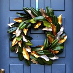 a blue door with a green and yellow wreath hanging on it's front door