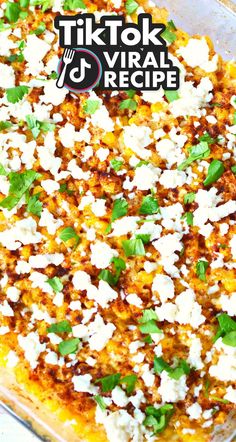 a close up of a casserole dish with cheese and herbs on it's surface