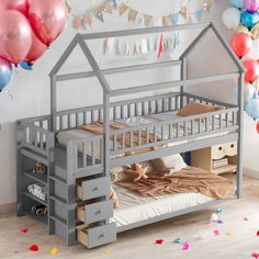 a child's bed that is made to look like a house with stairs and drawers