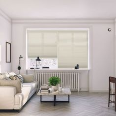 a living room filled with furniture and a window covered in blinds