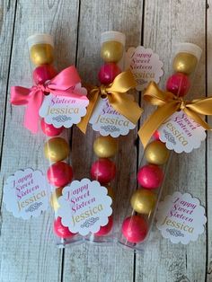 some candy sticks are wrapped in pink and gold