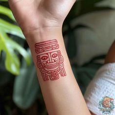 a woman's arm with a tattoo on it that has an image of a totem