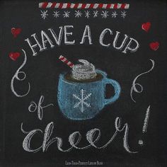 chalkboard sign saying have a cup of cheer with hot chocolate in a blue mug