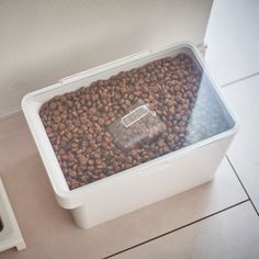 a dog food bowl on the floor next to a microwave