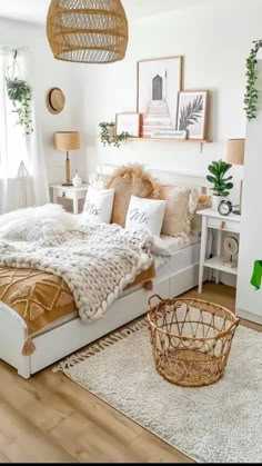 a bedroom with white walls, wooden floors and lots of greenery on the wall