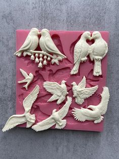 a pink tray with white birds on it