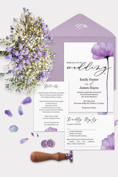 wedding stationery with purple flowers and calligraphy