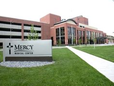 the medical center is located in front of a large building with a cross on it