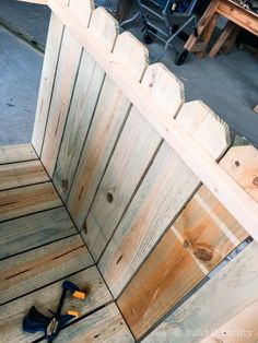 a pair of tools sitting on top of a wooden floor next to a fenced in area