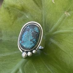 Gorgeous hubei turquoise ring handcrafted in sterling silver. Size is 7.25 This ring was created with a gorgeous piece of authentic oval turquoise, bezel set in sterling silver, accented with a wire cradle and 3 sterling balls, set on a sterling silver 1/4 inch hand stamped band! Perfect boho accessory for everyday wear. Handcrafted in my studio with love. Oval Turquoise Ring, Bohemian Hand Forged Turquoise Ring, Unique Handmade Turquoise Sterling Silver Ring, Handmade Unique Turquoise Sterling Silver Ring, Handmade Unique Turquoise Ring In Sterling Silver, Unique Hand Forged Turquoise Ring, Bohemian Sterling Silver Turquoise Ring Nickel Free, Artisan Turquoise Ring With Large Stone In Sterling Silver, Bohemian Silver Turquoise Ring Stamped 925