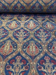 a blue and red rug with an intricate design on it's side, in the middle