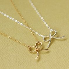 "A darling little hand made 14K gold filled bow is strung on a sparkling 14K gold filled chain. Perfect for layering! Necklace measures 16\" or 18\" from clasp to clasp. Bow measures approx .75 inches wide and .75 inches tall. Also available in silver. Simply select from drop down menu. ► All NINA KUNA jewels come in a complimentary jewelry bag. ► We love to layer our necklaces! Add a removable extender to get the perfect fit for your new or existing necklace: https://www.etsy.com/listing/226719 Gold Butterfly Knot Necklace For Gift, Gold Necklaces With Butterfly Knot For Gift, Gold Necklace With Butterfly Knot For Gift, 14k Gold Bow Jewelry, Gold Bow Necklaces For Gifts, Gold Necklaces With Bow For Gifts, Gold Necklaces With Bow As Gifts, Gold Dainty Bow Jewelry, Gold Necklace With Bow For Gifts