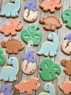 decorated cookies are arranged in the shape of dinosaurs