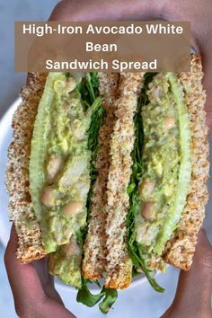 a sandwich with avocado and spinach on it in someone's hands