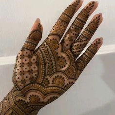 the hand is decorated with intricate designs