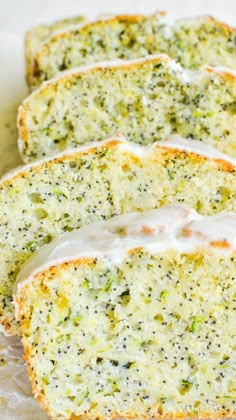 four slices of broccoli bread with white icing on top and green sprinkles