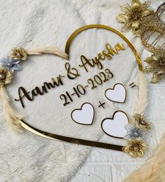 a heart shaped sign with two hearts on it and the words ann & august written in gold