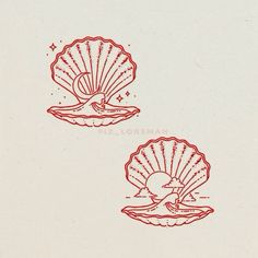 two red scallop shells sitting on top of a white surface