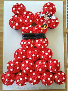 mickey mouse cupcakes are arranged in the shape of a teddy bear