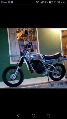 a motorcycle parked in front of a green building