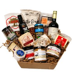 a wine and cheese gift box filled with gourmet food, condiments and snacks